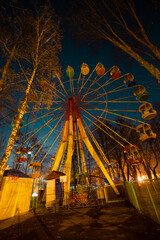 Empty Ferris wheel at night in an amusement park