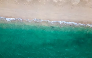 Draagtas Aerial drone view (top down) to sea waves and white sand. Turquoise blue water, tropical theme. Concept of relaxation in pure nature. © Martin