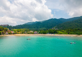 Fototapeta na wymiar Aerial drone view of bamboo bay and beach at Koh Lanta island, Thailand. Tropical forest near the rocky beach and white sand with turquoise water.