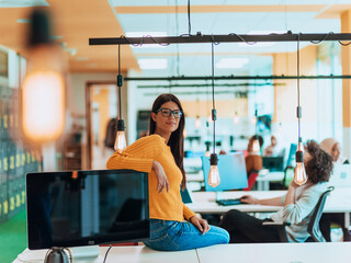 Female boss, manager executive posing in a modern startup office while being surrounded by her...