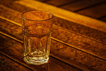 empty glass with rain drops on wooden table