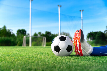 football soccer player stretching during warm up before kick ball in match league in stadium with healthy sport concept © kunchainub