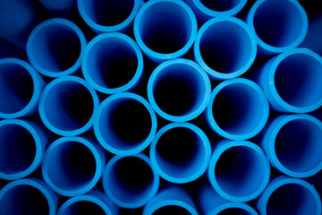 Background of the blue plastic pipes in stacked