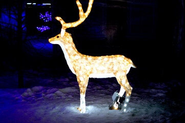 A model of a luminous deer from garlands stands in a city park