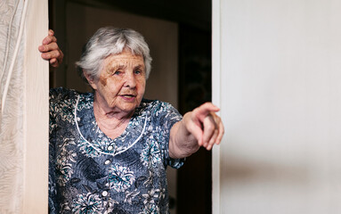 ninety-two-year-old white caucasian senior woman at home pointing finger.