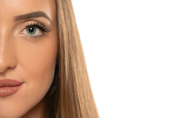 Obraz premium Beauty female eye with curl long false eyelashes on a white background