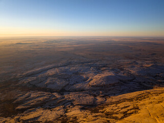 Bektau-Ata mountain range is triassic granite massif surrounded by a flat steppe. Wide-angle aerial view.