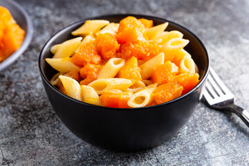 Penne pasta with pumpkin, typical autumn food. Ideal for vegan and vegetarian people.