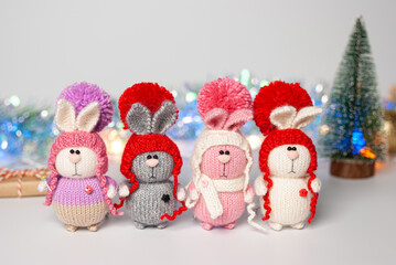 Handmade knitted bunny on a New Year's blurred background