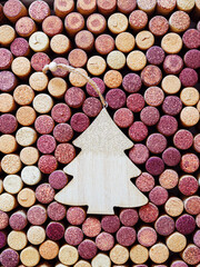 Wine corks with Christmas fir tree wooden toy as copy space, natural texture used bottle stoppers. Christmas background with close up wooden corks. New Year holidays wine concept