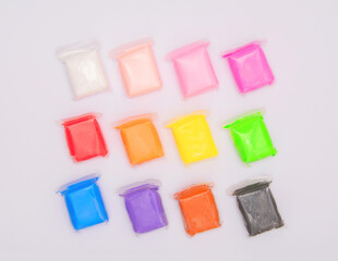 Vivid air plasticine, a soft colorful air mass for children's art that dries after modeling isolated on white background. Modeling clay for kids education and development.