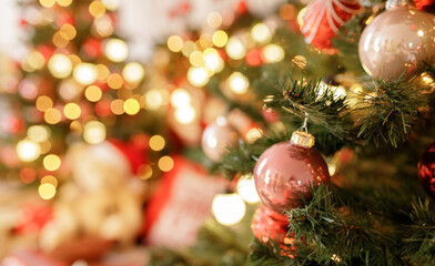 Close up of balls on christmas tree. Bokeh garlands in the background. New Year concept