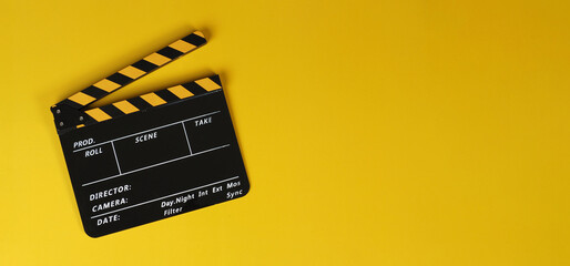 Fototapeta na wymiar Clapper board or yellow movie slate on yellow background.