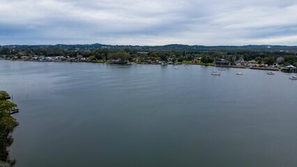 Aerial shot of Hastings River Port with scenic mountains and cloudscape in the background