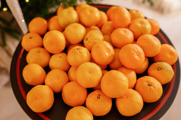 Christmas composition on colorful bokeh background. Mandarins against a background of blurry defocused lights. Concept for Christmas, New Year