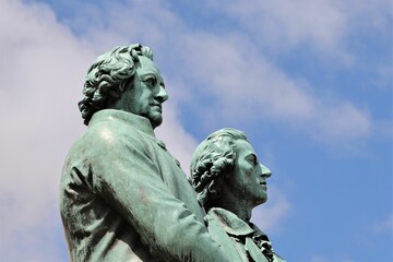 Closeup of Goethe-Schiller-Denkmal monument on blue cloudy sky background in Germany
