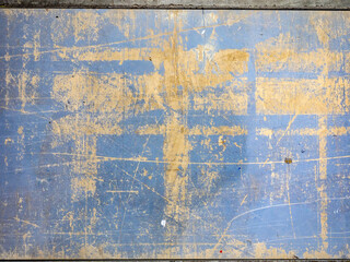 Old worn wall. Destroyed wooden surface. Worn board texture. Blackboard with peeling blue paint. Texture old wall. Wooden surface background. Board pattern with scratches. Texture with peeling paint