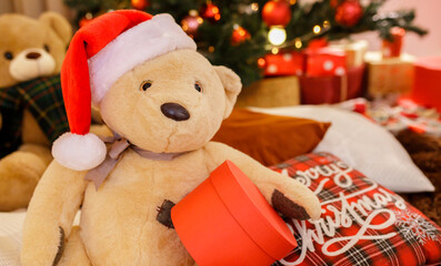 Teddy Bear in Christmas hat with Gift Box in Blur Background. Merry Christmas