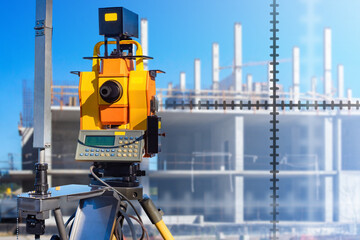 Geodetic work. Measurements using geodetic instrument. Engineering and geodetic surveys. Topographic survey during construction. Surveyors equipment is aimed at house under construction