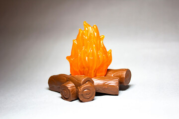 Plastic figurine bonfire with bokeh effect