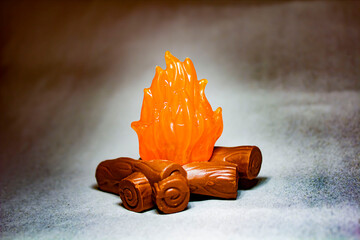 Plastic figurine bonfire with bokeh effect