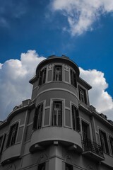 Fototapeta na wymiar Low-angle vertical of Psila Alonia neighborhood against cloudy sky background