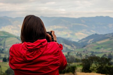 Closeup of a woman taking photos of the beautiful landscape