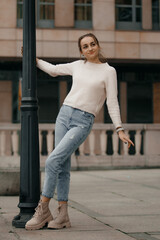 Young girl posing next to a lamp post.