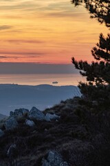 Vertical shot of sunset view from the top of a high cliff
