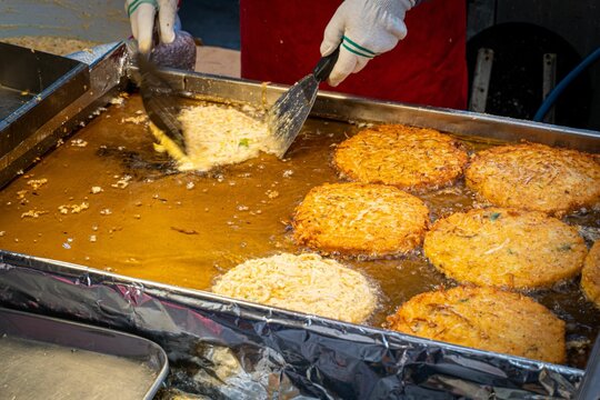 Closeup of frying mung bean pancakes (bindaetteok) in Gwangjang Market, Seoul