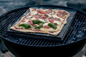 Closeup of pizza on grill stove