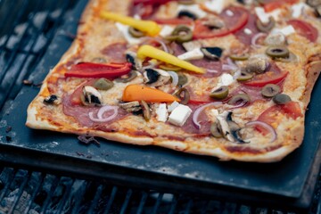 Closeup of pizza on grill stove