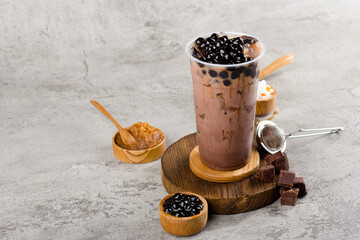 Boba or tapioca pearls is taiwan bubble milk tea in plastic cup with chocolate flavor on texture ...