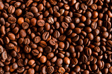 Dark roast coffee beans background, top view