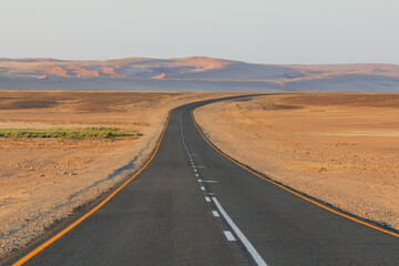 Fototapeta na wymiar Asphalt road to Soussusvlei, Namib-Naukluft National Park of Namibia.