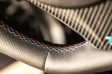 Fotobehang Luxury sport car steering wheel stitching © Filippo Carlot