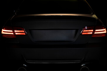Obraz na płótnie Canvas Sport tuned car rear view in the dark