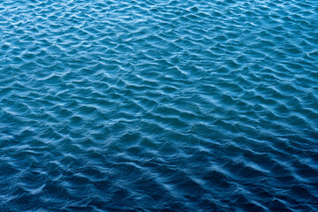 Blue sea surface with waves and ripples