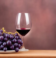 a glass of red wine with grapes nearby