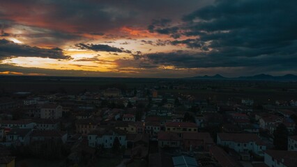 Aerial shot of the Bagnoli di Sopra commune in Italy, during an orange sunset