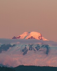 Vertical shot of a beautiful snow-capped mountain during a dreamy pinky sunset
