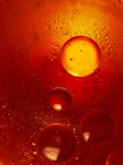 Macro shot of water drops on a glass with orange and red background