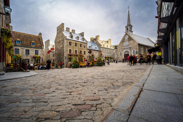 Fototapeta premium In the heart of the old town of Quebec there is the Place Royale where tourists admire the cobbled streets and stone houses of New France.