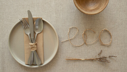 Home decor, natural style, eco friendly lifestyle concept. Ceramic plate, set of metal cutlery...