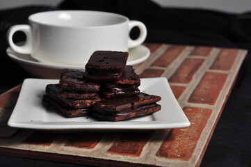 Chocolate covered biscuits on a white plate