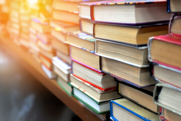 Old used books are on table in bookstore. Lot of books in stack at book flea market. Background.