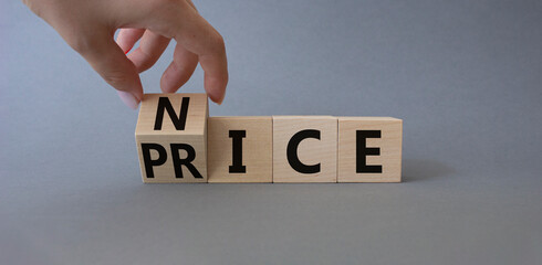 Nice and Price symbol. Businessman hand turns wooden cube and changes word Price to Nice. Beautiful grey background. Business and Nice and Price concept. Copy space.