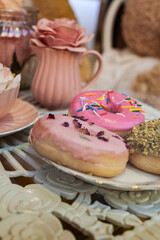 Assorted donuts with pink glazed and sprinkles donuts.