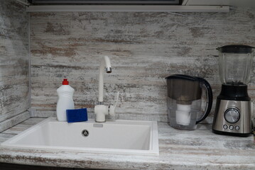 Electric food processor on kitchen countertop, kitchen sink on the background. kitchen applience concept