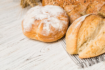 Homemade natural breads. Different kinds of fresh bread as background, perspective view with copy space
